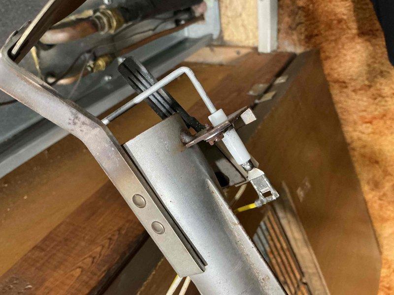 Performed scheduled maintenance on a 5-year-old furnace. Inspected burner assembly and heat exchanger, noting minor corrosion beginning to form. Checked ignitor functionality and electrical connections, particularly focusing on the yellow wiring. System is operational but recommended continued annual maintenance to monitor developing rust on metal components.