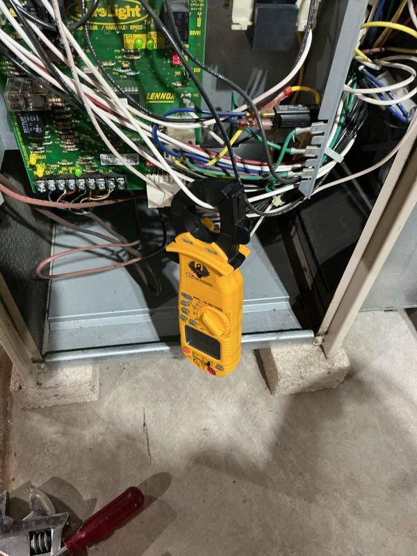Performed diagnostic testing on Lennox furnace system using clamp meter to measure electrical current through control board wiring. Temperature readings of 66.1°F were taken at the ductwork using SPK2 digital thermometer to verify proper airflow and system operation.