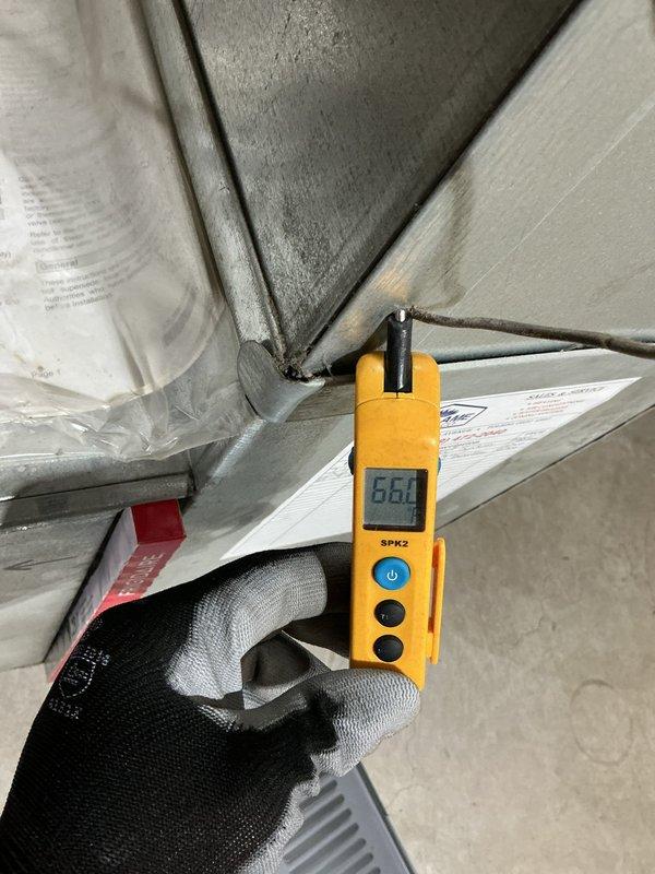 Performed diagnostic testing on Lennox furnace system using clamp meter to measure electrical current through control board wiring. Temperature readings of 66.1°F were taken at the ductwork using SPK2 digital thermometer to verify proper airflow and system operation.