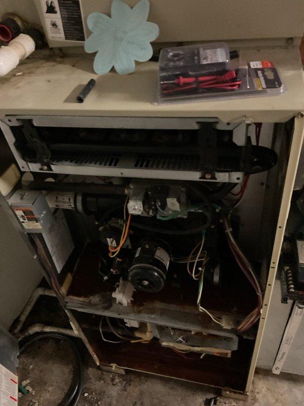 Conducted detailed inspection of existing furnace, documenting considerable wear on internal components including motor assembly and electrical wiring. Assessment revealed replacement as most suitable option due to age of unit and potential inefficiency. Proposed installation of new furnace system with proper integration to existing water filtration/humidifier components.