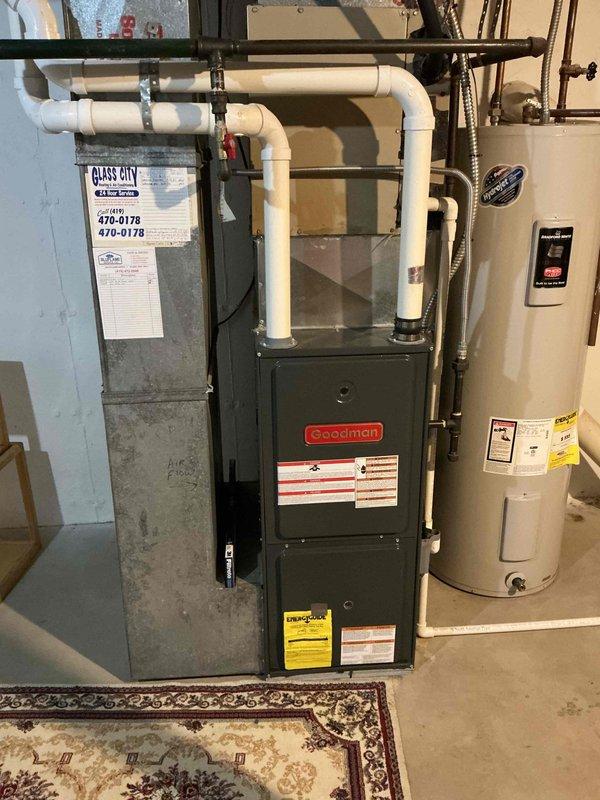 Performed 9-1 heating maintenance visit on Goodman furnace system. Inspected unit for proper operation, examined ductwork connections, and ensured appropriate venting through PVC exhaust pipes. Verified system components were functioning correctly with no visible issues in the utility room installation.