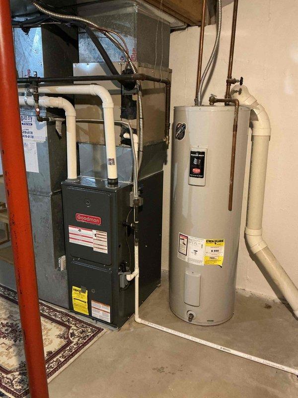Performed 9-1 heating maintenance visit on Goodman furnace system. Inspected unit for proper operation, examined ductwork connections, and ensured appropriate venting through PVC exhaust pipes. Verified system components were functioning correctly with no visible issues in the utility room installation.