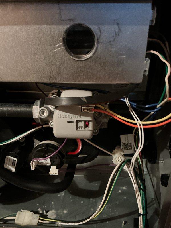 Performed standard furnace maintenance service with multimeter testing of electrical components, reading 506V. Inspected Honeywell control switch and verified proper connection of all wiring (white, green, red) to ensure system functionality and safe operation.