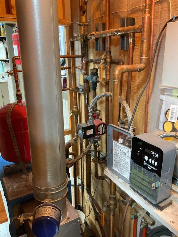 Completed comprehensive boiler estimate for Buderus heating system installation. Assessment included evaluation of existing copper piping network, expansion tank, pressure regulator, and ventilation components. Photos documented current system configuration in mechanical room to support detailed replacement proposal.