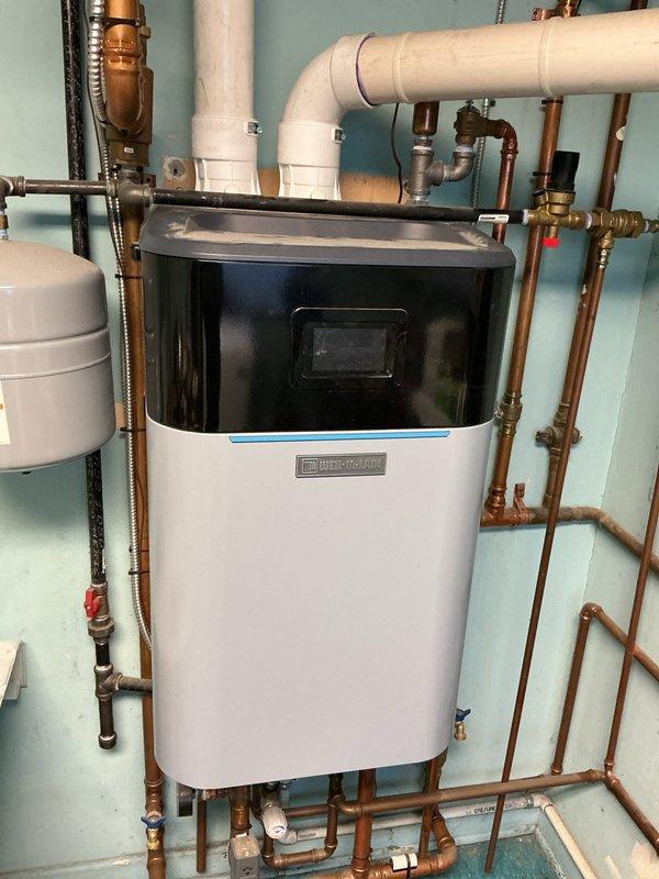 Diagnosed non-functioning tanked water heater (Weil-McLain brand) during same-day service appointment. Inspection revealed heating system with proper PVC ventilation and copper supply line connections. Performed necessary repairs to restore water heater functionality.