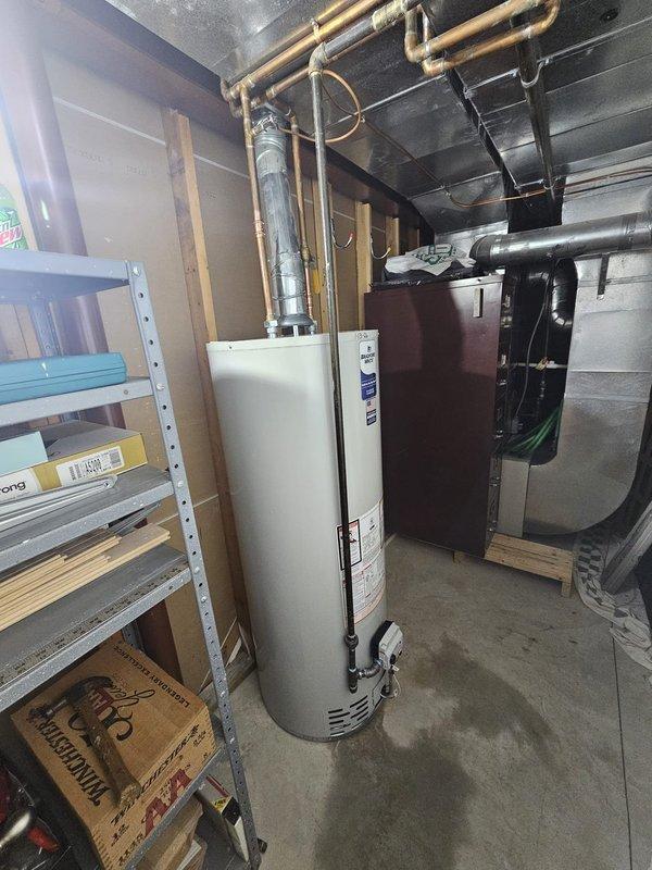 Successfully installed a 50-gallon Bradford natural gas, natural draft water heater in utility room. Connected copper supply lines and properly vented with metal flue pipe to existing ductwork. Drained old tank using 20ft hose into bathroom.