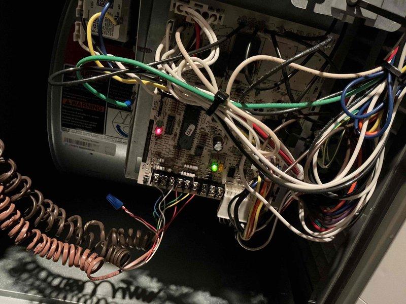 Responded to service call for furnace with illuminated red LED indicator following recent maintenance. Performed diagnostic inspection of PCB control board, finding electrical fault. Repaired circuit board connections and verified proper operation of system with green LED now illuminated. Furnace returned to normal working condition and is functioning correctly.