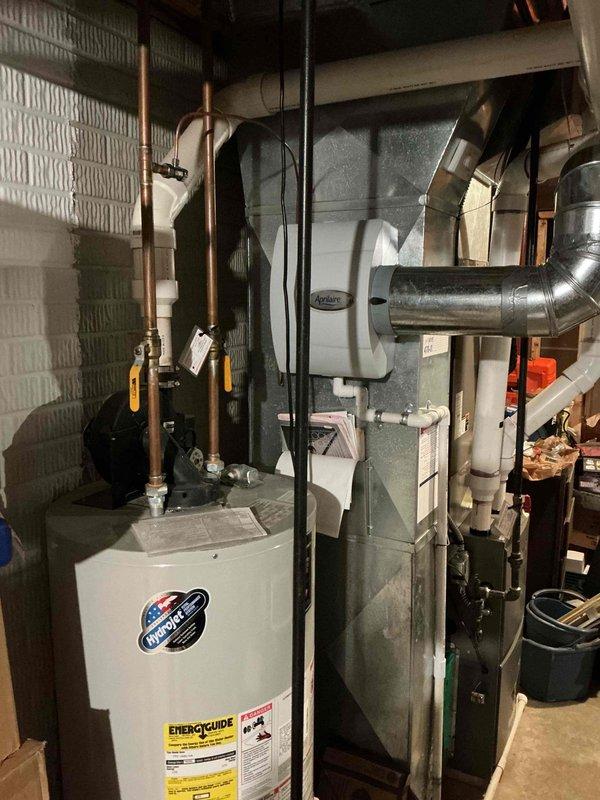 Performed standard furnace tune-up maintenance service on residential HVAC system. Inspected furnace unit, connections, and ductwork; all components found in normal operating condition with no visible issues. System is properly installed with appropriate connections to water heater and ventilation.