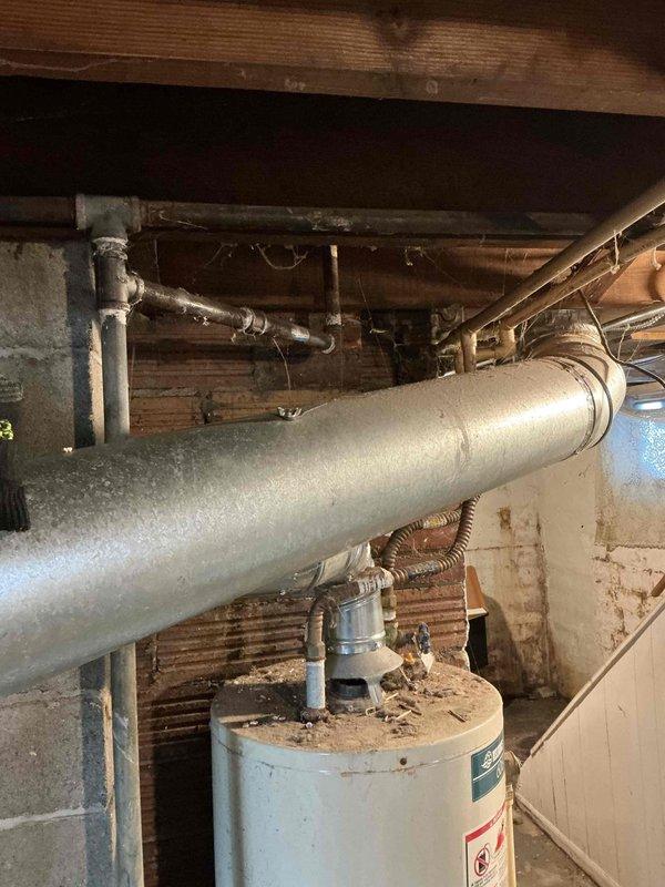 Completed tune-up service on 5-year-old furnace. Inspected system components including heat exchanger, burners, and flue pipes. Cleaned and checked adjacent water heater connections for proper operation. All systems functioning normally with no issues detected.