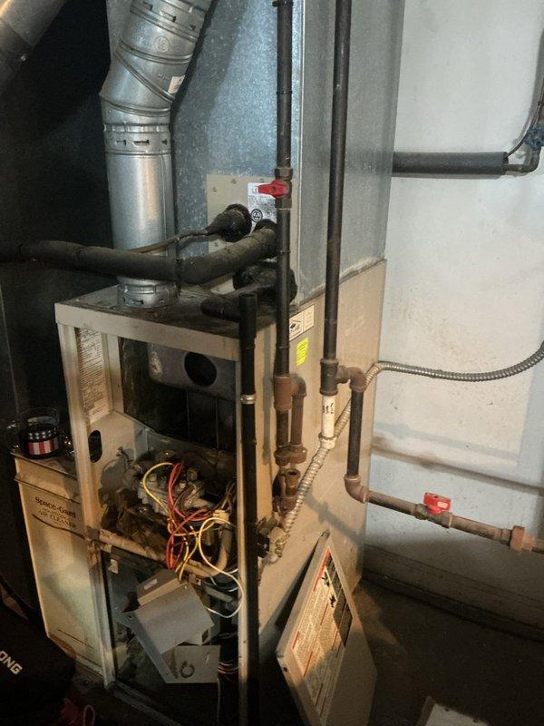 Responded to service call for non-operational furnace in residential property. Inspected 28-year-old WINNER unit with open access panel revealing deteriorated wiring and aging components. Performed diagnostic testing on heat exchanger and control systems, identifying end-of-life failure points consistent with the unit's advanced age. Customer previously had furnace installation services from our company.