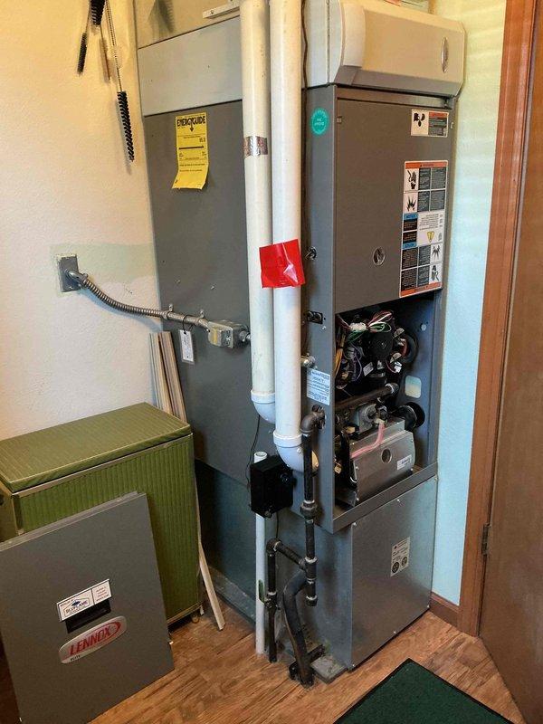 Performed annual maintenance on 13-year-old gas furnace system. Inspected Lennox equipment, checked all connections and components. Opened front panel to examine blower motor, control board, and internal wiring - all functioning properly. Verified proper venting through PVC pipes, noted appropriate labeling and warning stickers intact. System operating within normal parameters after service.