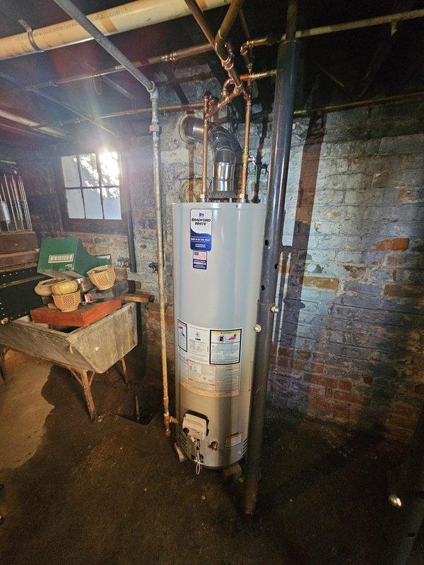 Successfully installed a new 40-gallon water heater in basement utility room. Connected copper inlet and outlet pipes to the unit and ensured proper venting. Installation complete and system functioning as expected.
