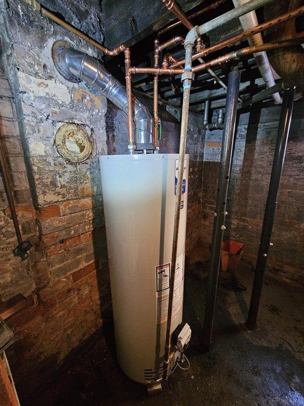 Successfully installed a new 40-gallon water heater in basement utility room. Connected copper inlet and outlet pipes to the unit and ensured proper venting. Installation complete and system functioning as expected.
