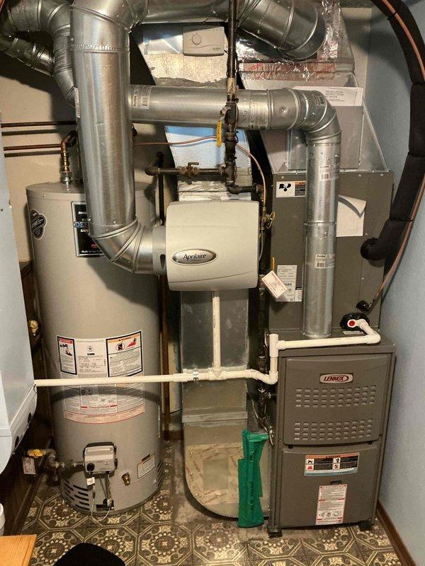 Completed scheduled heating maintenance service on Lennox furnace system. Inspected furnace, associated ductwork, Aprilaire air treatment unit, and PVC exhaust components. System appears properly installed in utility room with no visible issues noted.