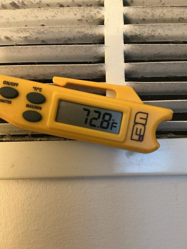 Performed diagnostic temperature testing on heating system, measuring supply air temperature at 97.7°F while return air registered at 72.8°F, confirming proper temperature differential of approximately 25°F. Noted significant dust accumulation on vent registers requiring cleaning to maintain optimal airflow and system efficiency.