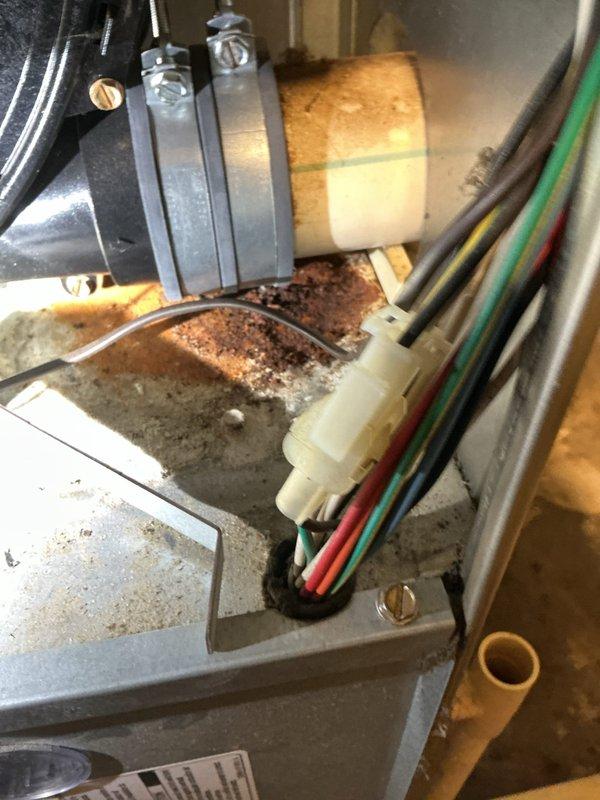 Responded to no heat complaint on aging HVAC system (10+ years old). Inspection revealed significant rust and corrosion at heat exchanger connections with visible deterioration of the metal housing. Replaced failed ignition assembly and corroded gas valve components to restore proper heating function.