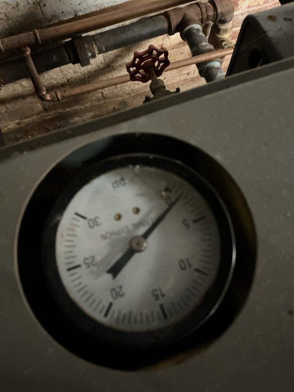 Performed scheduled furnace maintenance tune-up. Inspected pressure gauge readings which showed normal operation. Replaced worn electrical connection bracket and associated wiring components to ensure proper system functionality and prevent potential failure.