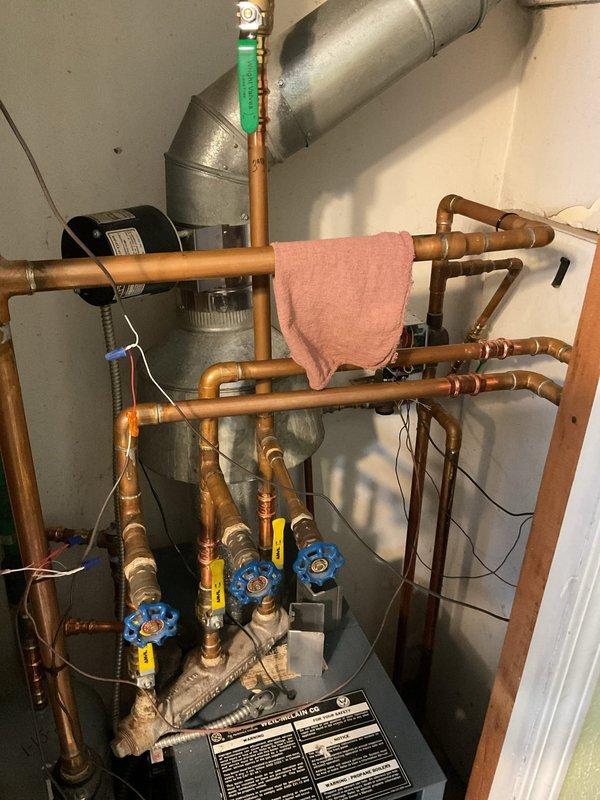 Performed assessment of existing boiler system for replacement estimate. Current unit shows extensive copper piping network with multiple valves and has required significant recent repairs. Inspection revealed aging components throughout the heating system, with the current boiler appearing to be at end of life based on maintenance history and visual inspection.