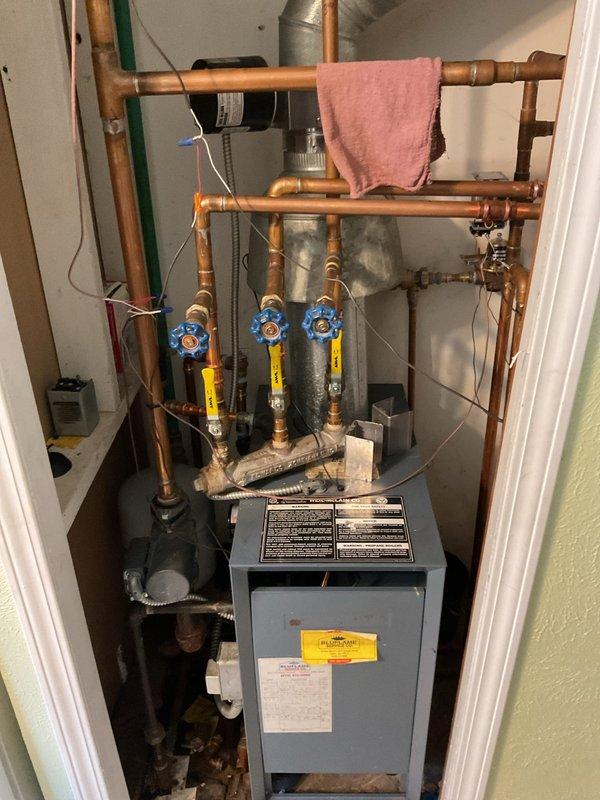 Performed assessment of existing boiler system for replacement estimate. Current unit shows extensive copper piping network with multiple valves and has required significant recent repairs. Inspection revealed aging components throughout the heating system, with the current boiler appearing to be at end of life based on maintenance history and visual inspection.