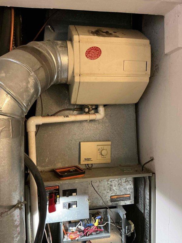Performed routine maintenance tune-up on 5+ year old furnace. Inspected electrical components and connections, noting minor corrosion on metal framework. Examined Aprilaire control system and verified proper operation of ductwork and electrical panel. Unit is functional but showing expected signs of age-related wear.