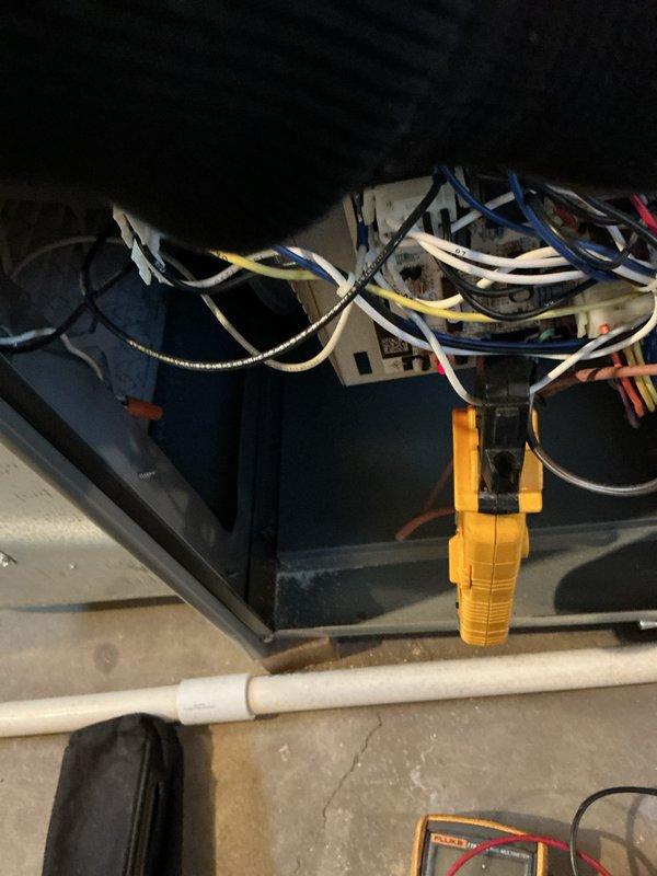Performed routine maintenance on a 4-year-old furnace. Conducted electrical testing with Fluke 116 multimeter, measuring resistance at 50.7 ohms. Inspected control box wiring connections and verified proper terminal connections for white, blue, yellow, and orange wires.