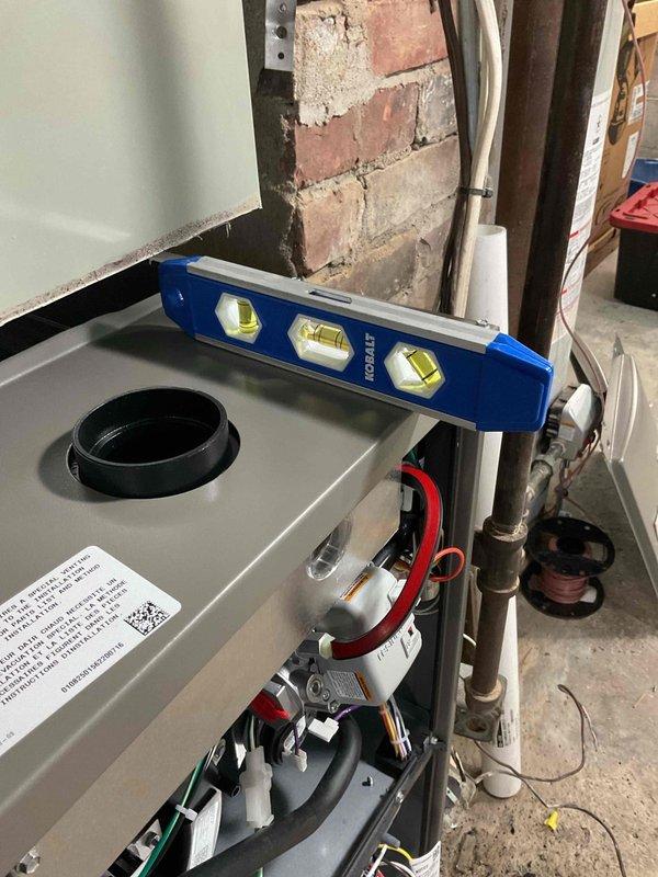 Successfully installed a 96% high efficiency 70k BTU upflow furnace, converting it to 90k BTU as specified. Unit was properly leveled and elevated on blocks due to client's basement water issues. Capped exhaust to chimney, installed metal venting, and relocated the Honeywell T6 Pro thermostat to designated location. System includes 10-year parts warranty, 1-year labor warranty, and 1-year maintenance.