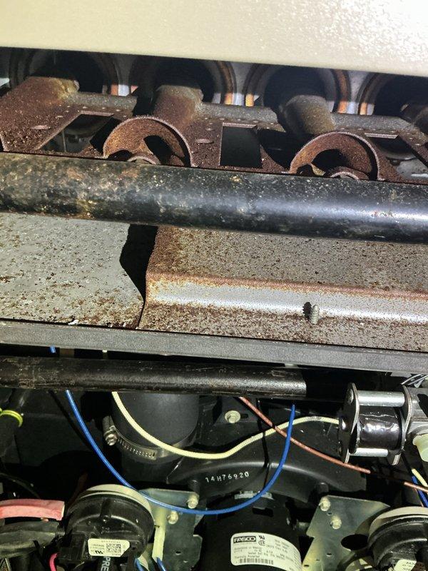Responded to no-heat call for furnace that was rumbling then shutting down. Visual inspection revealed severe corrosion on burner assembly with significant rust accumulation on heat exchanger components. Determined rust buildup was causing improper combustion and triggering safety shutdown.