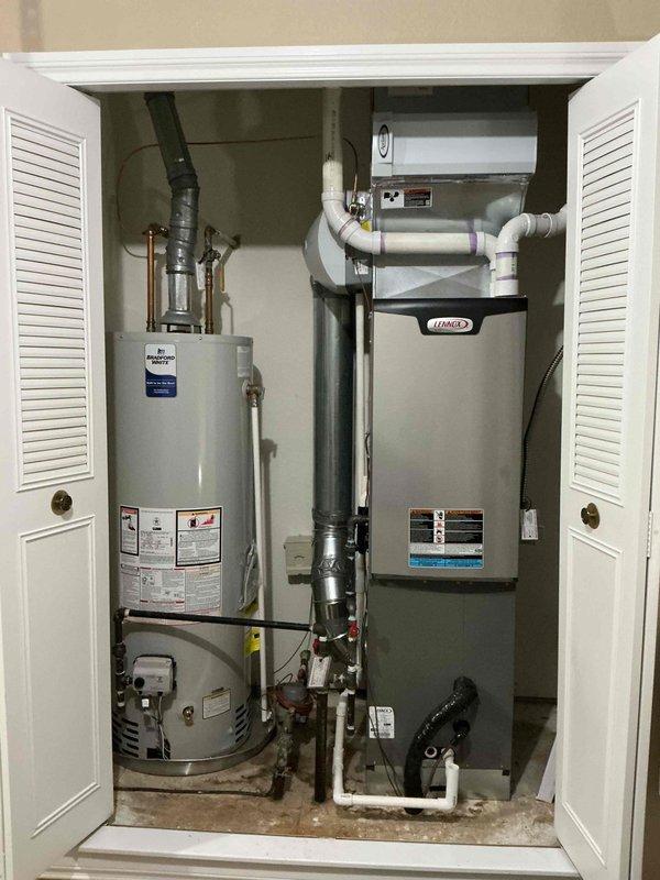 Performed scheduled furnace maintenance on Lennox HVAC system. Inspected installation where customer reported misaligned holes compared to previous unit. Verified all connections, ventilation system (including PVC pipes with purple markings at joints), and proximity to water heater were within code requirements and functioning properly.