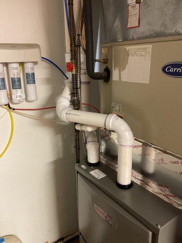 Successfully installed a new Carrier furnace in the utility area, ensuring proper leveling of the unit for optimal performance. Completed installation of the PVC condensate drainage system with appropriate elbow joints, connecting it to the existing plumbing infrastructure.