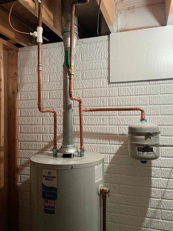 Responded to emergency service call for Bradford White water heater that had developed a significant leak. Upon inspection, determined unit required replacement. Successfully installed new Bradford White tanked water heater with proper copper line connections and expansion tank. Verified all connections were secure, restored water and gas service to home, and confirmed proper operation before completing service.
