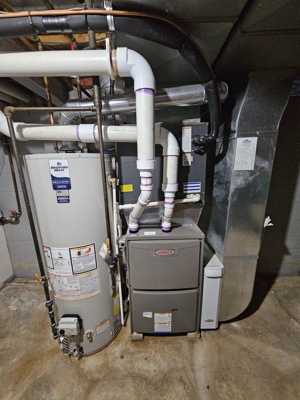 Successfully installed a Lennox 90kbtu 96% efficient upflow gas furnace with required metal spacer in residential mechanical room. Installed Honeywell T6 Pro thermostat and replaced 50 gallon water heater. Verified proper leveling of all equipment and confirmed all connections to existing ductwork and PVC ventilation system are secure and operational.