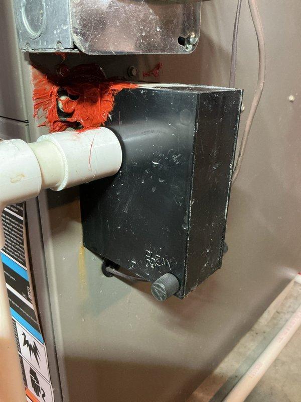 Performed routine furnace maintenance under annual contract. Identified red sealant leakage at pipe connections and degraded orange gasket material with condensation present on control housing. Applied fresh sealant and replaced deteriorated gasket to prevent future leaks and ensure proper system operation.