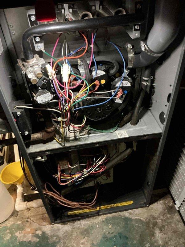 Performed routine maintenance on 10-year-old natural gas furnace. Inspected interior components including electrical connections, wiring, and control circuits. Examined Amana furnace unit with connected ventilation system and Space-Gard air cleaner, ensuring proper operation for the heating season.