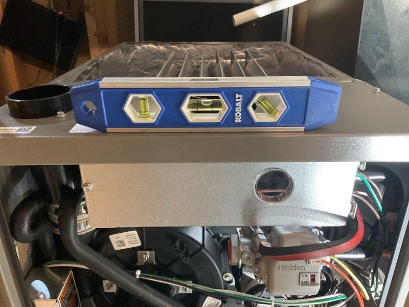 Installed new furnace unit and verified proper leveling using carpenter's level on both horizontal and vertical planes. Completed connection of electrical wiring and internal components. Unit is operational with proper airflow through ventilation system.