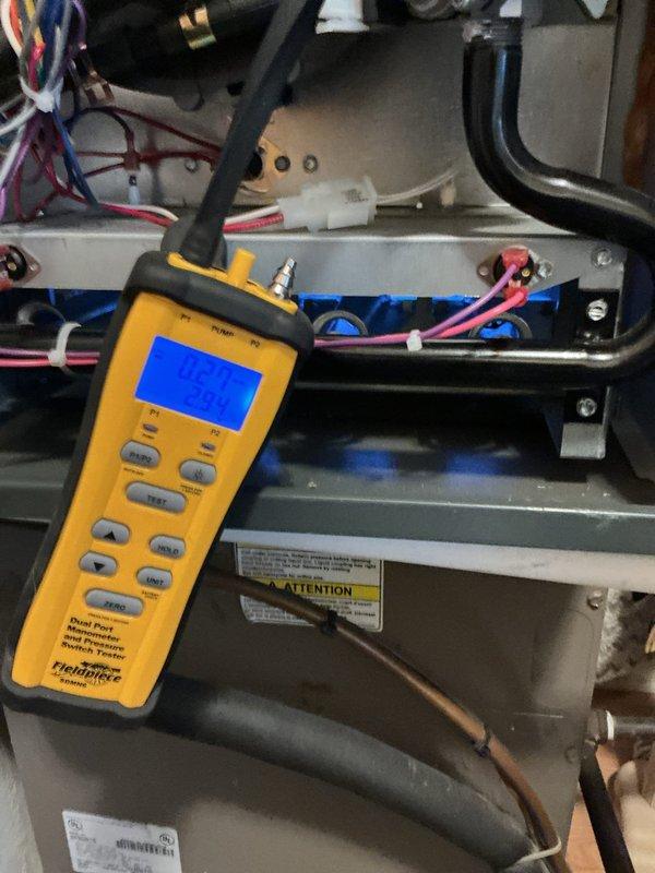 Responded to no heat complaint with furnace short cycling. Performed pressure testing using Fieldpiece manometer which revealed inadequate gas pressure. Inspected PVC venting system with digital gauge showing 67.5 reading. Diagnosed and corrected pressure switch circuit issue that was causing the system to short cycle, restoring proper heating operation.