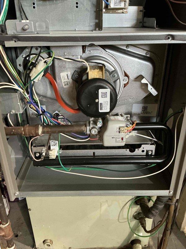 Performed routine maintenance on a 6-year-old furnace. Inspected blower motor assembly and electrical connections, confirming proper wire routing and secure connections. Examined water heater installation and ventilation system to ensure safe operation and proper clearances. All components tested and functioning correctly.