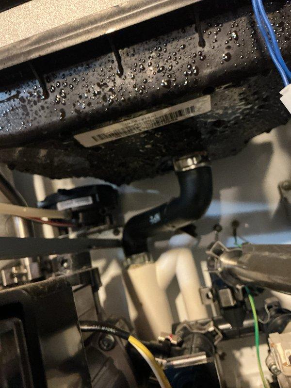 Responded to service call for tankless water heater displaying error code 89e-10 and non-operational status. Upon inspection, found excessive condensation on internal components affecting system operation. Removed front panel to access and diagnose internal systems, cleaned affected components, and reset error code. Unit now functioning properly with no error codes present.