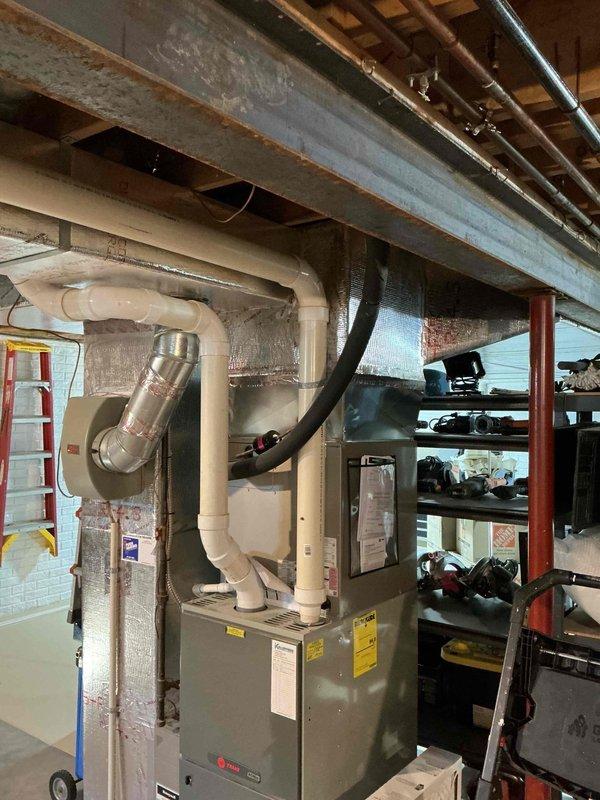 Responded to service call for humidifier leak. Inspected Trane furnace system in basement mechanical area with associated ductwork and PVC exhaust components. Identified source of humidifier leak and performed necessary repairs to resolve the issue.
