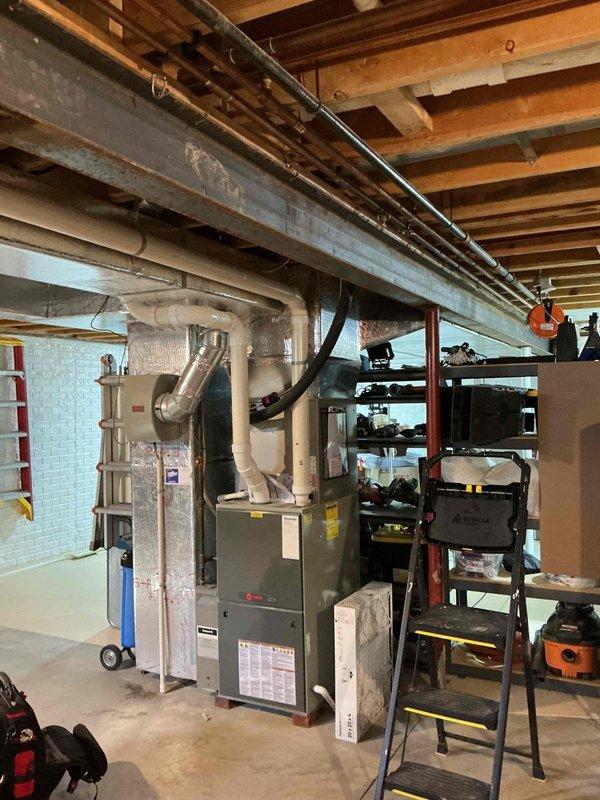 Responded to service call for humidifier leak. Inspected Trane furnace system in basement mechanical area with associated ductwork and PVC exhaust components. Identified source of humidifier leak and performed necessary repairs to resolve the issue.