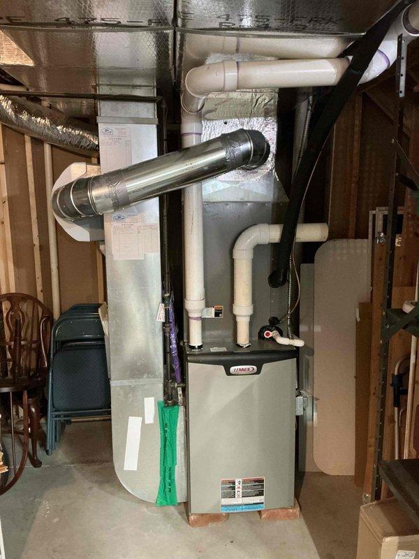 Performed scheduled heating maintenance service on Lennox furnace system located in basement utility area. Inspected complete heating system including connected ductwork, PVC ventilation pipes, and whole-house humidifier. All components found in proper working condition with no issues identified.