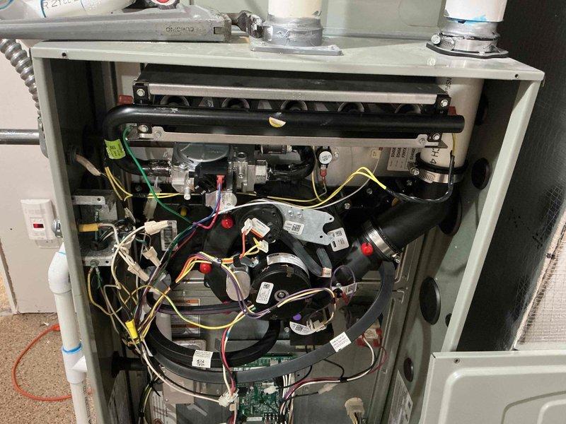 Responded to gas odor complaint in furnace room. Inspection revealed improper furnace intake configuration drawing air from utility room instead of outside. Corrected ventilation setup by properly routing PVC intake pipe to external air source, eliminating gas smell when room door is closed. Verified proper system operation after modifications.