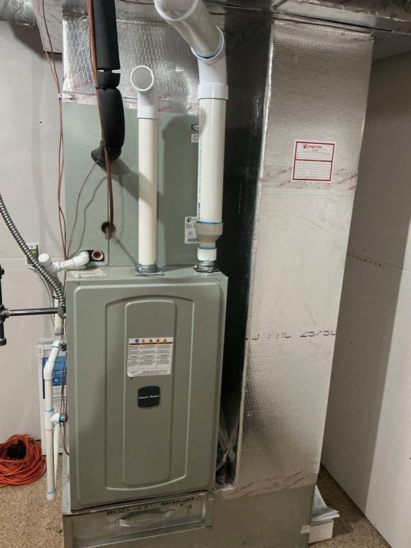 Responded to gas odor complaint in furnace room. Inspection revealed improper furnace intake configuration drawing air from utility room instead of outside. Corrected ventilation setup by properly routing PVC intake pipe to external air source, eliminating gas smell when room door is closed. Verified proper system operation after modifications.