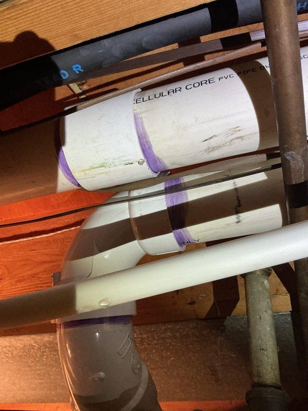 Responded to service call for furnace condensation pipe leak. Identified corrosion and mineral buildup at pipe junction with valve. Repaired leaking connection at the PVC condensate drain line to resolve the issue.