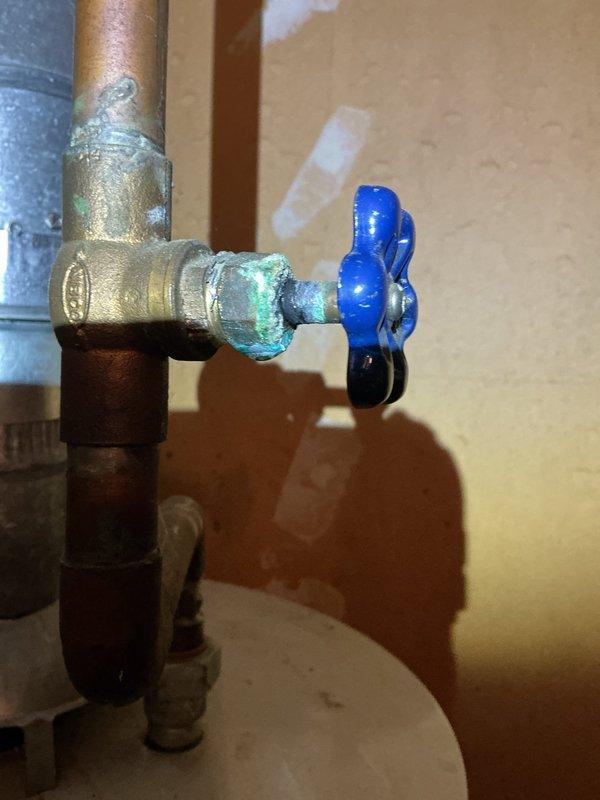 Responded to service call for furnace condensation pipe leak. Identified corrosion and mineral buildup at pipe junction with valve. Repaired leaking connection at the PVC condensate drain line to resolve the issue.