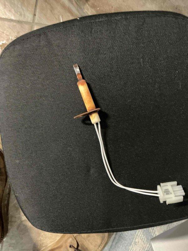 Performed routine maintenance on 11-year-old natural gas furnace. Inspected igniter and control assembly, noting some rust staining on heat exchanger surfaces. System operational with igniter and gas valve functioning correctly.