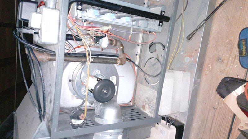 Responded to no-heat call for furnace blowing cold air. Diagnostic inspection revealed failed ignition system preventing flame ignition while blower continued operation. Multimeter testing confirmed faulty flame sensor with 1.00 ohm reading. Replaced flame sensor, cleaned ignition assembly, and verified proper system operation with normal heat output restored.