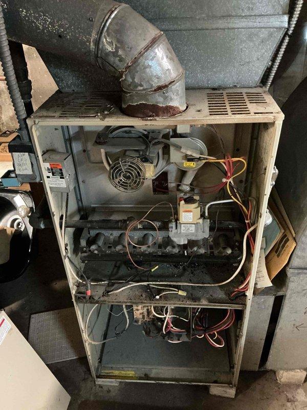 Responded to no-heat call on 20+ year old natural gas furnace. Performed diagnostic inspection revealing significant dust accumulation on internal components and signs of rust on ductwork. Cleaned critical components and restored heating functionality. Advised customer that system shows advanced age-related wear and may require replacement in near future.