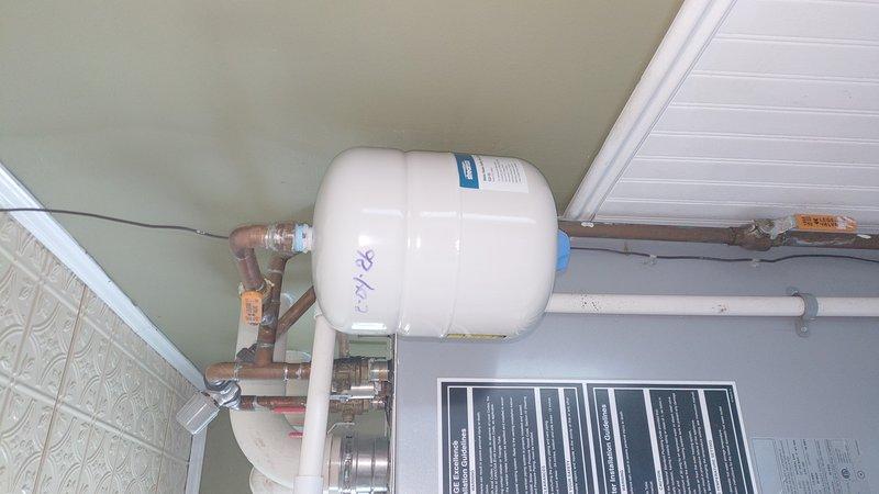 Installed two expansion tanks as requested by customer. Mounted one white cylindrical tank to the ceiling and positioned a light blue expansion tank within the existing plumbing system. Connected both tanks to copper piping with appropriate valves and fittings to ensure proper system pressure regulation. All components were successfully integrated with the existing boiler system.