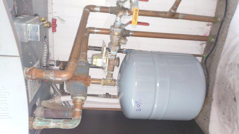 Installed two expansion tanks as requested by customer. Mounted one white cylindrical tank to the ceiling and positioned a light blue expansion tank within the existing plumbing system. Connected both tanks to copper piping with appropriate valves and fittings to ensure proper system pressure regulation. All components were successfully integrated with the existing boiler system.