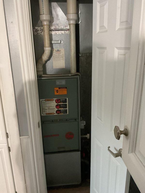 Conducted final quote assessment for HVAC system replacement. Current setup includes an aging Trane XE 1200 outdoor unit showing signs of winter exposure and snow accumulation, paired with an indoor furnace installed in utility closet with standard PVC venting. Replacement recommendation prepared based on visual inspection of both components.